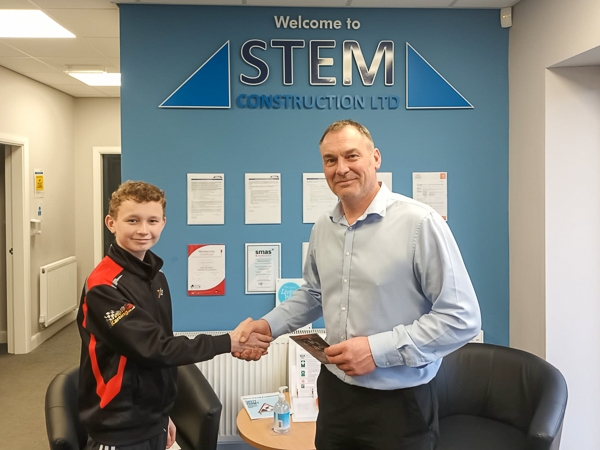 Tom Holden shakes hands on his new sponsorship deal with STEM Construction's Steve Thornley